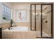 Luxurious bathroom with a soaking tub, a separate shower, and warm neutral tile work at 13103 Union Square Dr, Huntersville, NC 28078