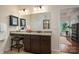 Well-lit bathroom with granite counters, makeup vanity, and dark wood cabinetry at 13103 Union Square Dr, Huntersville, NC 28078