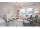 Charming Bedroom with pink walls, white crib, gray chair, and bright windows at 13103 Union Square Dr, Huntersville, NC 28078