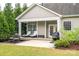 Spacious covered patio featuring seating, a grill, and access to the home's backyard and outdoor space at 13103 Union Square Dr, Huntersville, NC 28078