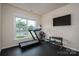 Bright workout room with a treadmill, weights, and a large window offering outdoor views at 13103 Union Square Dr, Huntersville, NC 28078