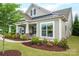 Inviting front porch with stone accents, manicured landscaping and craftsman architectural details at 13103 Union Square Dr, Huntersville, NC 28078