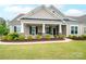 Charming home featuring a covered porch and well-maintained front yard with lush green grass at 13103 Union Square Dr, Huntersville, NC 28078