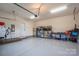 Spacious garage featuring epoxy flooring, ample storage, and an electric vehicle charging station at 13103 Union Square Dr, Huntersville, NC 28078