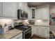 Well-equipped kitchen featuring granite countertops, stainless steel appliances, and custom cabinetry at 13103 Union Square Dr, Huntersville, NC 28078