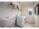 Functional laundry room with sink, shelving, and modern washer and dryer at 13103 Union Square Dr, Huntersville, NC 28078