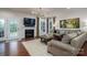 Inviting living room with fireplace, large sectional, and ample natural light, and open floor plan at 13103 Union Square Dr, Huntersville, NC 28078