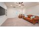 Spacious living room with plush carpet, ceiling fan, tan walls, and comfortable leather seating at 13103 Union Square Dr, Huntersville, NC 28078