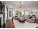 Bright living room with hardwood floors, decorative lighting, fireplace, and open floor plan at 13103 Union Square Dr, Huntersville, NC 28078