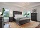 Spacious main bedroom with a tray ceiling, chandelier, rug, and large windows for natural light at 13103 Union Square Dr, Huntersville, NC 28078