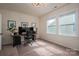 Bright home office featuring a large desk with multiple monitors and natural light from dual windows at 13103 Union Square Dr, Huntersville, NC 28078