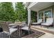 Cozy patio with an outdoor dining set and comfortable lounge chairs surrounded by lush landscaping at 13103 Union Square Dr, Huntersville, NC 28078
