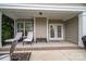 Covered patio with lounge chairs offers a relaxing outdoor space for enjoying the weather at 13103 Union Square Dr, Huntersville, NC 28078