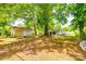 Spacious backyard showcasing a detached garage and mature trees, offering a serene and private outdoor setting at 1430 Bose Ave, Rock Hill, SC 29732