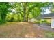 Expansive backyard with mature trees and a detached garage, perfect for outdoor activities and storage at 1430 Bose Ave, Rock Hill, SC 29732