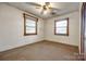 This bedroom has neutral walls and carpet with two windows at 1430 Bose Ave, Rock Hill, SC 29732