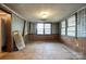 Versatile empty room with paneled walls, large windows for natural light, ready for customization at 1430 Bose Ave, Rock Hill, SC 29732