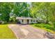 Quaint home exterior with a covered carport, a grassy lawn, and a paved driveway, inviting you to call it home at 1430 Bose Ave, Rock Hill, SC 29732