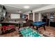Finished basement with a games area with billiards table, pinball machine, foosball, and a cozy seating area at 145 Meadow Pond Ln, Mooresville, NC 28117