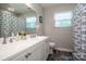 Bathroom featuring double sinks, a large mirror, and fish themed decor at 145 Meadow Pond Ln, Mooresville, NC 28117