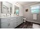 Bathroom with double sink vanity, modern finishes, and a large mirror at 145 Meadow Pond Ln, Mooresville, NC 28117