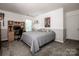 Neutral bedroom with wall decor, a bed, and an office space at 145 Meadow Pond Ln, Mooresville, NC 28117