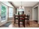 Inviting dining area with access to the backyard, featuring a wooden table with seating and view of the living room at 145 Meadow Pond Ln, Mooresville, NC 28117