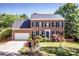 Two story brick home with an attached two car garage and manicured front lawn at 145 Meadow Pond Ln, Mooresville, NC 28117