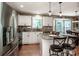 Bright kitchen with granite countertops, stainless steel appliances, white cabinetry, and an island with barstool seating at 145 Meadow Pond Ln, Mooresville, NC 28117