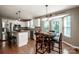 Open kitchen with granite counters, stainless steel appliances, white cabinets, island seating, and a view to the dining area at 145 Meadow Pond Ln, Mooresville, NC 28117