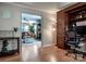 Open concept living area featuring built-in office furniture and view to a cozy living room at 145 Meadow Pond Ln, Mooresville, NC 28117
