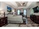 Spacious bedroom featuring a tray ceiling, dark wood floors, ceiling fan and wooden furniture at 145 Meadow Pond Ln, Mooresville, NC 28117