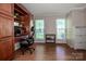 Office area boasting built-in shelving, hardwood floors, and natural light at 145 Meadow Pond Ln, Mooresville, NC 28117