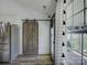 This kitchen features a barn door, stainless fridge, and backyard access at 1488 Meadow Glen Ln, Rock Hill, SC 29730