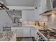 This is a kitchen with grey backsplash, stainless vent hood, and granite countertops at 1488 Meadow Glen Ln, Rock Hill, SC 29730