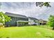 Expansive backyard view featuring well-maintained lawn, fence, and the home's exterior at 15312 Ravenall Dr, Huntersville, NC 28078