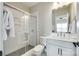 Modern bathroom with a glass-enclosed shower, single vanity, and neutral decor at 15312 Ravenall Dr, Huntersville, NC 28078