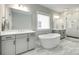 Luxurious bathroom featuring double vanities, a soaking tub, and a separate glass-enclosed shower at 15312 Ravenall Dr, Huntersville, NC 28078