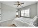 Comfortable bedroom featuring plush carpeting, ceiling fan, and a large window at 15312 Ravenall Dr, Huntersville, NC 28078