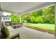 Relaxing covered patio showcasing a comfortable seating area with views of the lush backyard at 15312 Ravenall Dr, Huntersville, NC 28078
