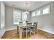 Cozy dining area featuring natural light, hardwood floors, and a rustic table with seating for four at 15312 Ravenall Dr, Huntersville, NC 28078