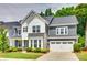Charming two-story home with a manicured lawn and a two-car garage, showcasing its appealing curb appeal at 15312 Ravenall Dr, Huntersville, NC 28078