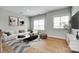 Contemporary living room with stylish furniture, large windows, and hardwood flooring throughout at 15312 Ravenall Dr, Huntersville, NC 28078