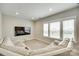 Entertainment room featuring a comfortable sectional sofa, large windows, and plush carpeting at 15312 Ravenall Dr, Huntersville, NC 28078