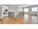 Bright foyer with hardwood floors, staircase, and iron railing welcomes you to this lovely home at 15312 Ravenall Dr, Huntersville, NC 28078
