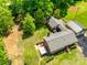 Aerial view showcasing the home, backyard with firepit, patio with gazebo, detached garage, and surrounding trees at 1540 Neely Store Rd, Rock Hill, SC 29730