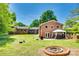 Beautiful backyard with a fire pit, patio, and well-maintained lawn at 1540 Neely Store Rd, Rock Hill, SC 29730