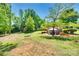 Expansive backyard featuring a patio, gazebo, fire pit, and mature trees perfect for outdoor entertaining and relaxation at 1540 Neely Store Rd, Rock Hill, SC 29730