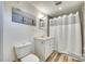 Bathroom with modern vanity, new flooring, and shower with white curtain at 1540 Neely Store Rd, Rock Hill, SC 29730