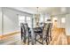 Dining area featuring a large wooden table, ample seating, and natural light from the adjacent kitchen and windows at 1540 Neely Store Rd, Rock Hill, SC 29730